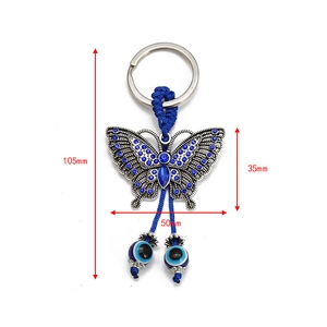 Detailed view of evil eye butterfly keychain with blue rhinestones and dimensions shown