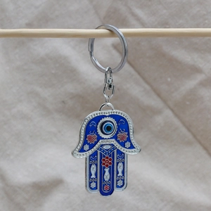Detailed Hamsa Hand keychain with blue evil eye enamel and silver floral patterns