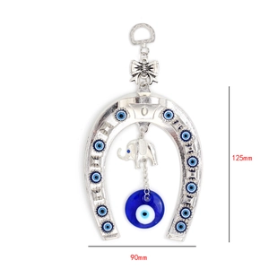 Detailed wall hanging with silver horseshoe evil eye beads and elephant pendant