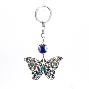 Vintage filigree butterfly keychain with evil eye bead and sparkling blue rhinestones