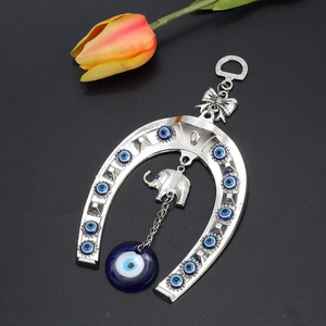 Detailed silver horseshoe wall hanging with evil eye beads and elephant pendant charm
