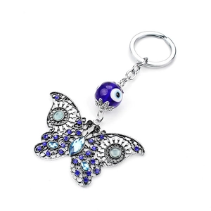 Detailed close-up of butterfly evil eye keychain with blue crystals and silver finish