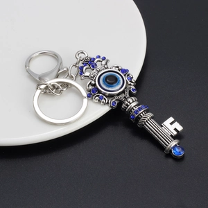 Vintage zinc alloy evil eye key pendant keychain with blue rhinestones and crown detail
