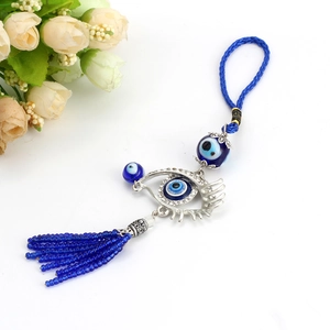 Lucky Turkish Evil Eye charm featuring a rhinestone metal eye and blue glass bead tassel