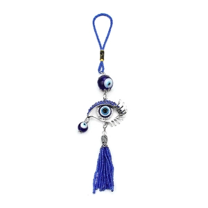 Detail of Turkish blue Evil Eye lucky charm with silver metallic eye and beaded tassels