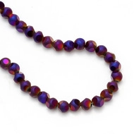 Macro shot of iridescent purple and blue faceted evil eye beads for DIY jewelry making