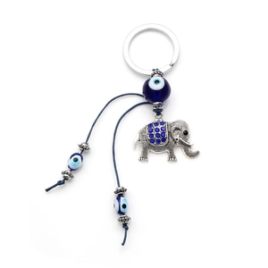 Detailed view of lucky elephant keychain with blue evil eye beads and blue rhinestones