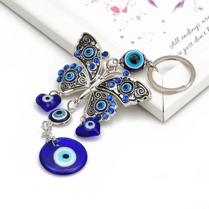 Detail of butterfly keychain with blue evil eye charms and sparkling blue rhinestones