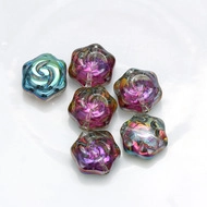 Detailed macro view of six colorful flower-shaped glass evil eye charms for DIY jewelry making