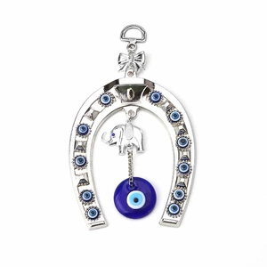 Silver horseshoe wall hanging with evil eye beads and small elephant pendant decoration