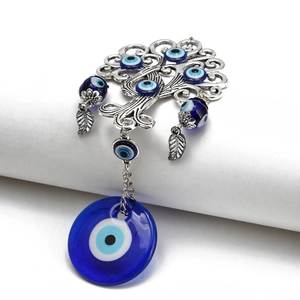 Detailed view of Tree of Life evil eye hanging ornament with blue glass beads and silver finish