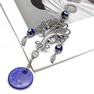 Detail of Tree of Life keychain with blue Evil Eye beads and glass disc pendant