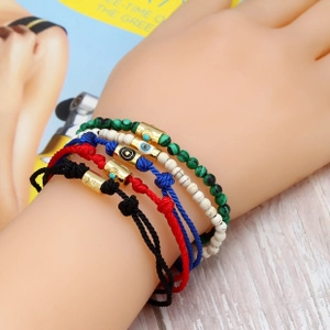 Bohemian five-piece bracelet set featuring evil eye charms and colorful woven beads