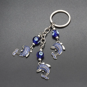 Portachiavi delfino malocchio blu con metallo argentato e ciondoli con strass lucidi