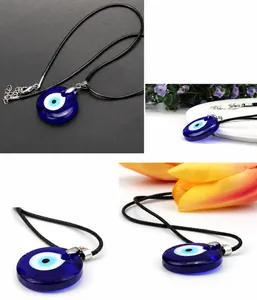 Macro detail of deep blue glass Evil Eye pendant with black wax cord and lobster clasp