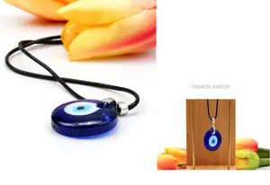 Detailed view of translucent blue Evil Eye glass pendant with a black cord necklace cord