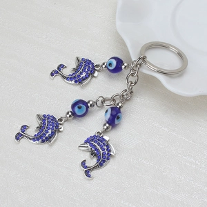 Portachiavi con delfini e occhio del male blu con pendenti in metallo e strass brillanti