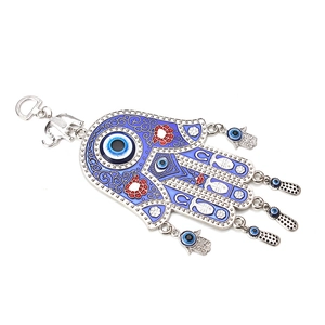 Detail of Hamsa Hand ornament with blue enamel evil eye and elephant charms