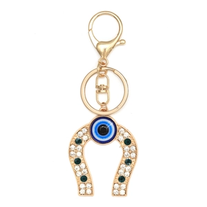 Golden horseshoe keychain with blue evil eye bead and sparkling crystal rhinestones
