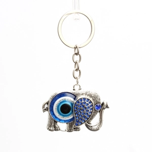 Porte-clés éléphant argenté avec l'œil porte-bonheur bleu et strass scintillants