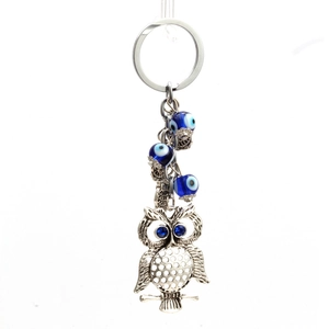 Porte-clés chouette argenté avec perles œil bleu et décoration en strass étincelants