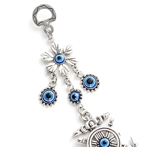 Detail of anchor charm with blue evil eye beads and silver alloy floral patterns