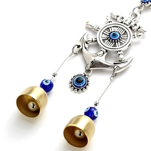 Nautical anchor wind chime with devil eye beads and golden bells on white background