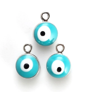 Detailed view of three blue Evil Eye charms with silver metal rings for DIY jewelry making