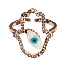Detailed macro of rose gold Hamsa ring with evil eye motif and cubic zirconia