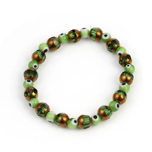 Detail shot of Evil Eye beaded bracelet with green and bronze textured beads on white background