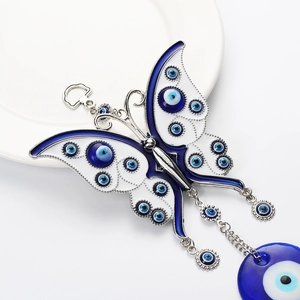 Detailed macro of Evil Eye butterfly wall hanging with blue enamel and silver metal links