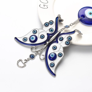 Ornamental butterfly keychain with blue evil eye charms and silver metal chain decoration