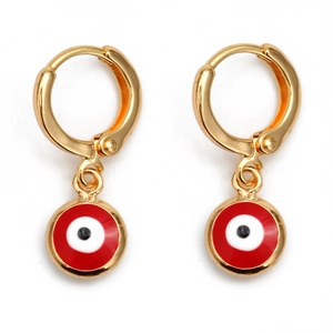 Macro shot of gold hoop earrings featuring red and white enamel evil eye charms