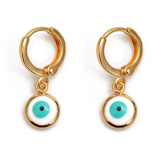 Detail of gold hoop earrings featuring hanging blue devil eye pendants on white backdrop