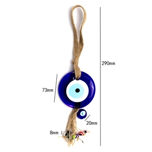 Detailed view of Turkish Evil Eye wall hanging with blue glass eye and jute tassel
