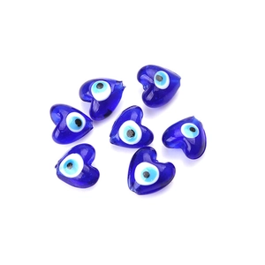 Detailed macro view of heart-shaped blue glass evil eye beads for DIY jewelry making