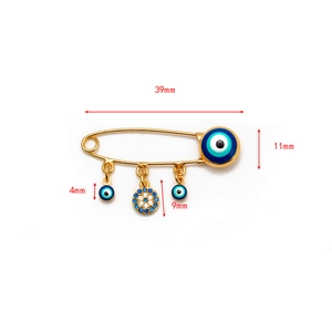Detail showing dimensions of the golden evil eye brooch with blue crystal pendants
