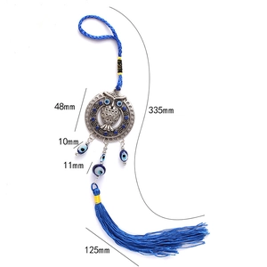 Detailed view of owl and evil eye pendant with deep blue tassel and dimensions shown