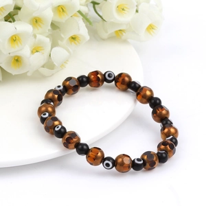 Detail of bohemian evil eye beaded bracelet with amber leopard print faceted crystals