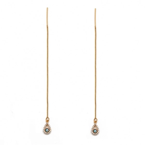 Macro detail of long gold threader earrings featuring evil eye charms and zircon accents