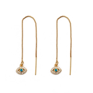 Detailed view of gold threader earrings featuring turquoise and zircon evil eye charms