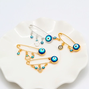 Lucky Evil Eye safety pin brooches with Hamsa Hand pendants in gold and silver finish