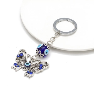 Butterfly key ring with evil eye beads and sparkling blue rhinestones on silver metal