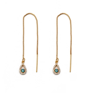 Detailed macro view of long 18K gold evil eye threader earrings with blue beads and zircons