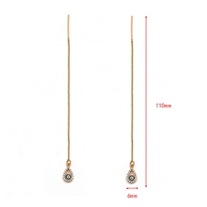 Detail of gold evil eye threader earrings showing 110mm length and blue crystal teardrop