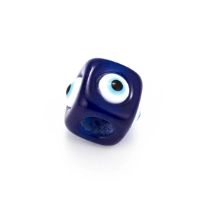 Macro detail of a dark blue cubic Evil Eye bead with a central hole for jewelry DIY