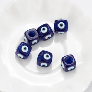 Macro detail of square evil eye resin beads for DIY jewelry making in dark blue color