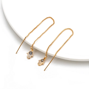 Detailed view of gold threader earrings featuring Hamsa Hand charms with blue zircon