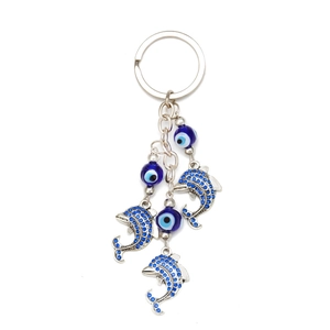 Detail of silver dolphin key ring with blue evil eye beads and sparkling crystal rhinestones