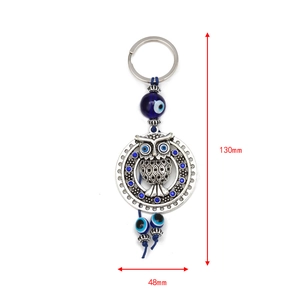 Silver Evil Eye owl keychain with blue crystals and hanging beads for bag decor